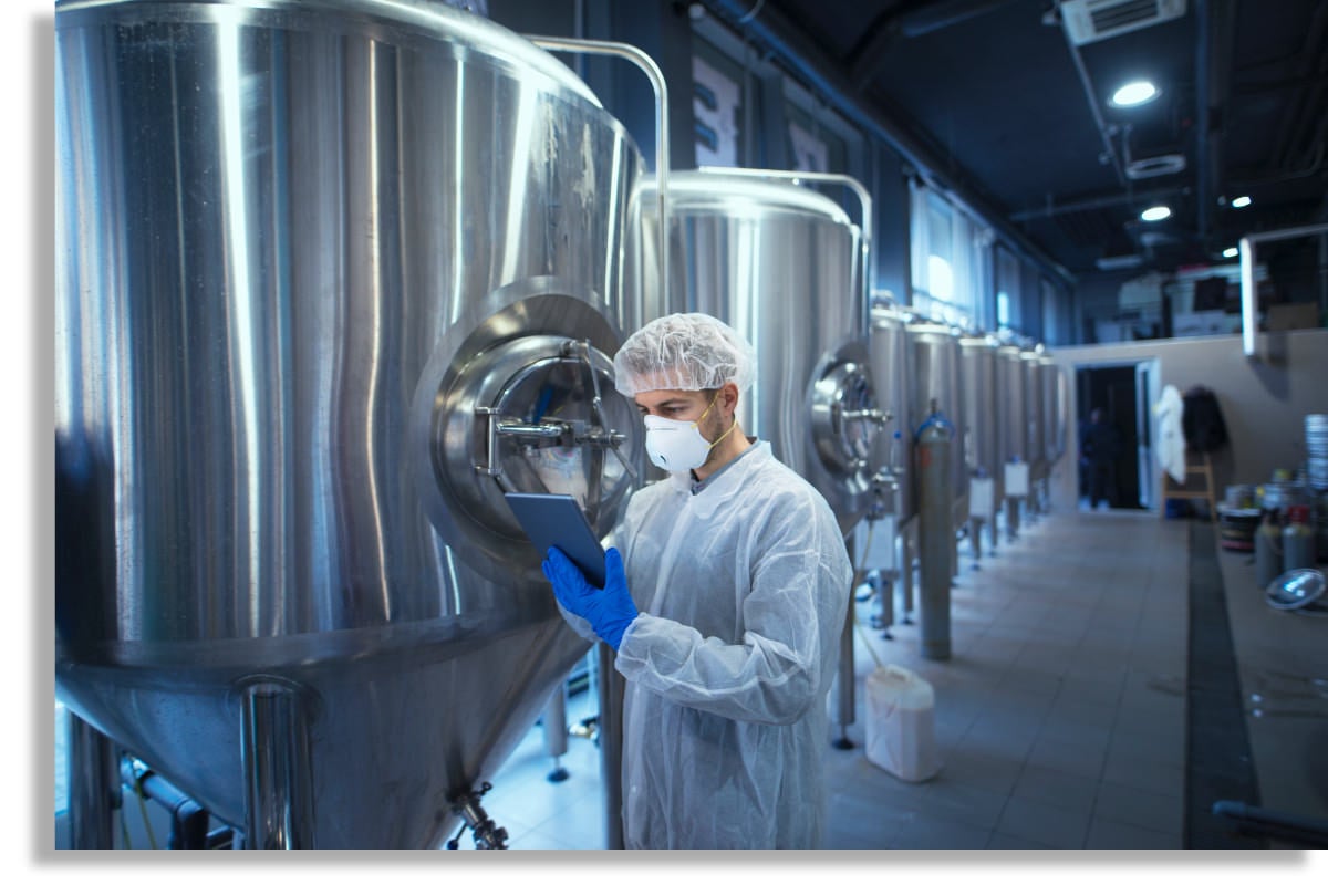 factory-worker-technologist-protective-uniform-with-hairnet-mask-controlling-food-production-tablet-computer - 1150px shadow